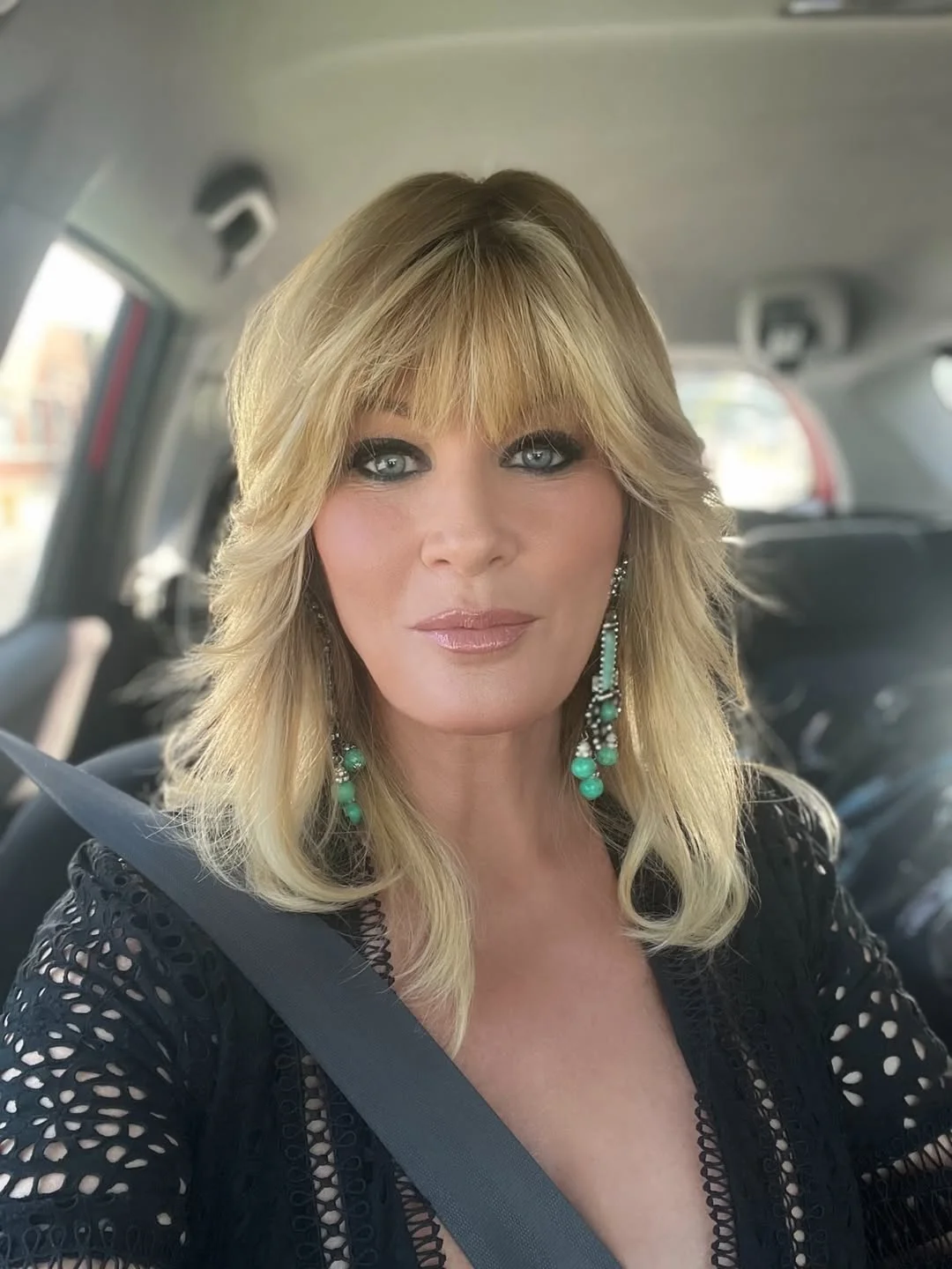 classy summer haircuts for women over 60 2026 Layered Blonde Medium Shag with Full Fringe