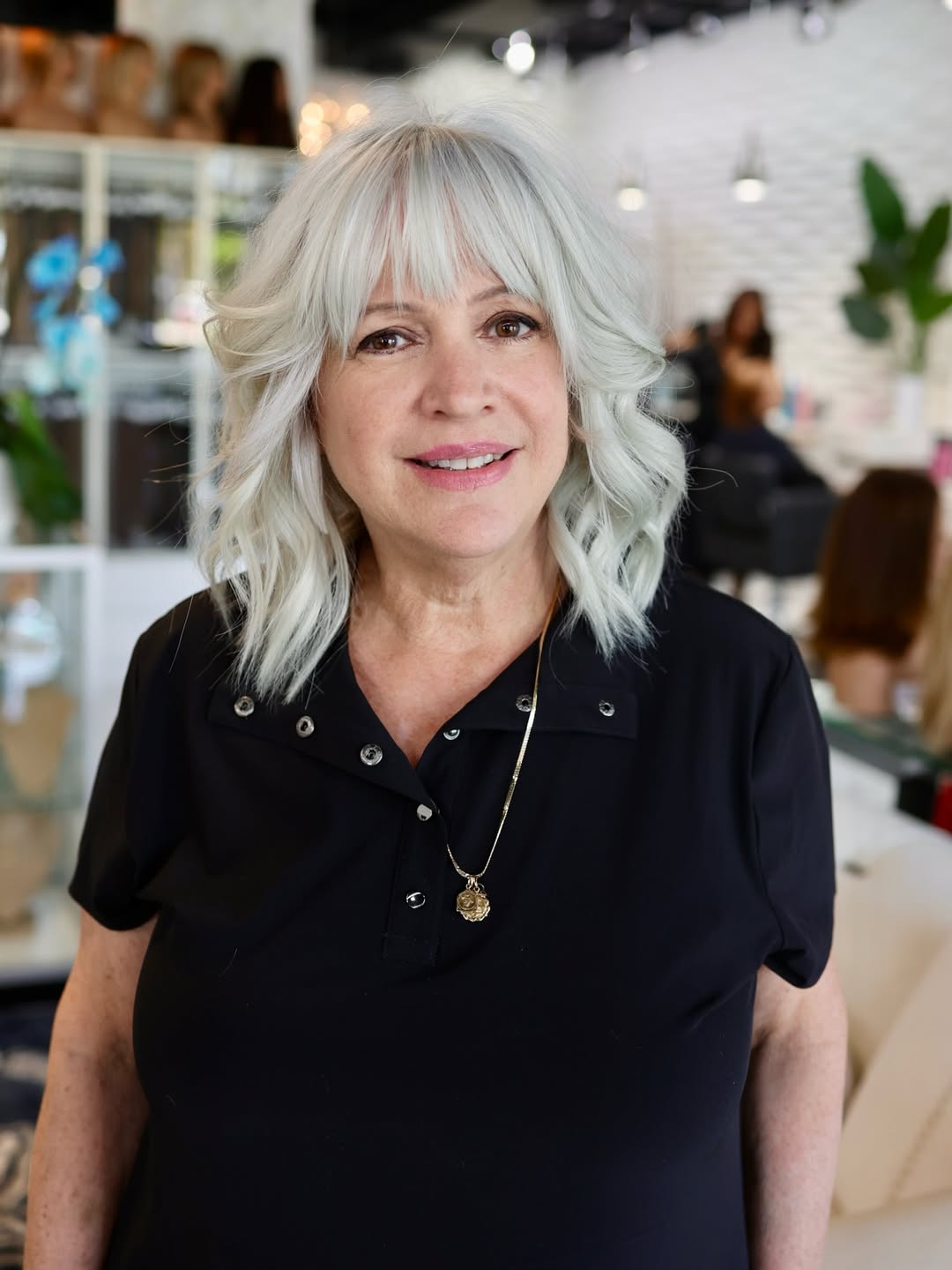 elegant summer haircuts for women over 50 2026 Soft Layered Shag with Wispy Bangs