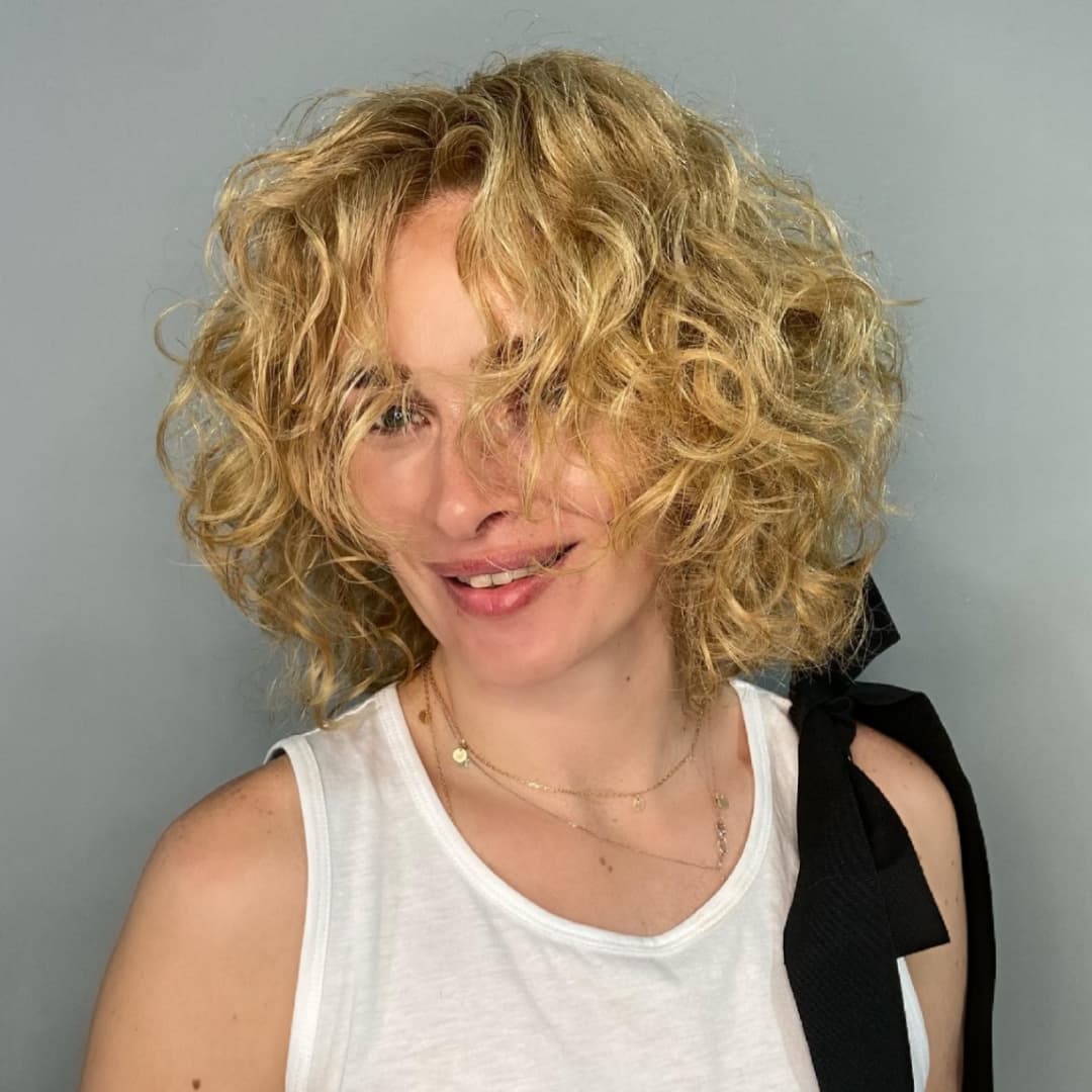 elegant summer haircuts for women over 50 2026 Short Curly Shag with Volume