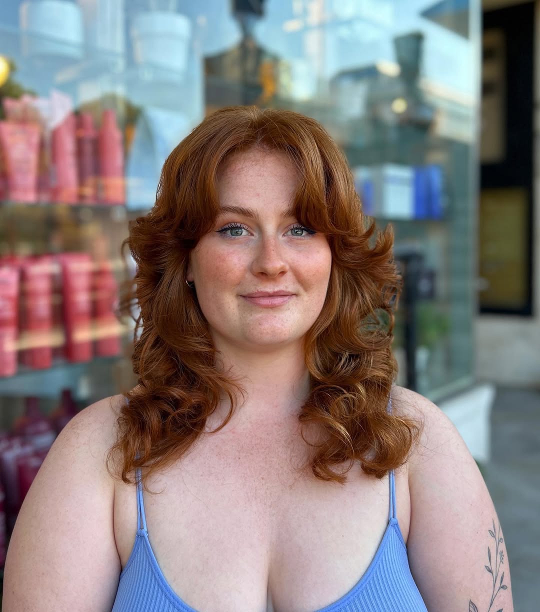 face-framing summer haircuts for plus size women 2026 Feathered Mid Length Copper Layers with Curtain Bangs