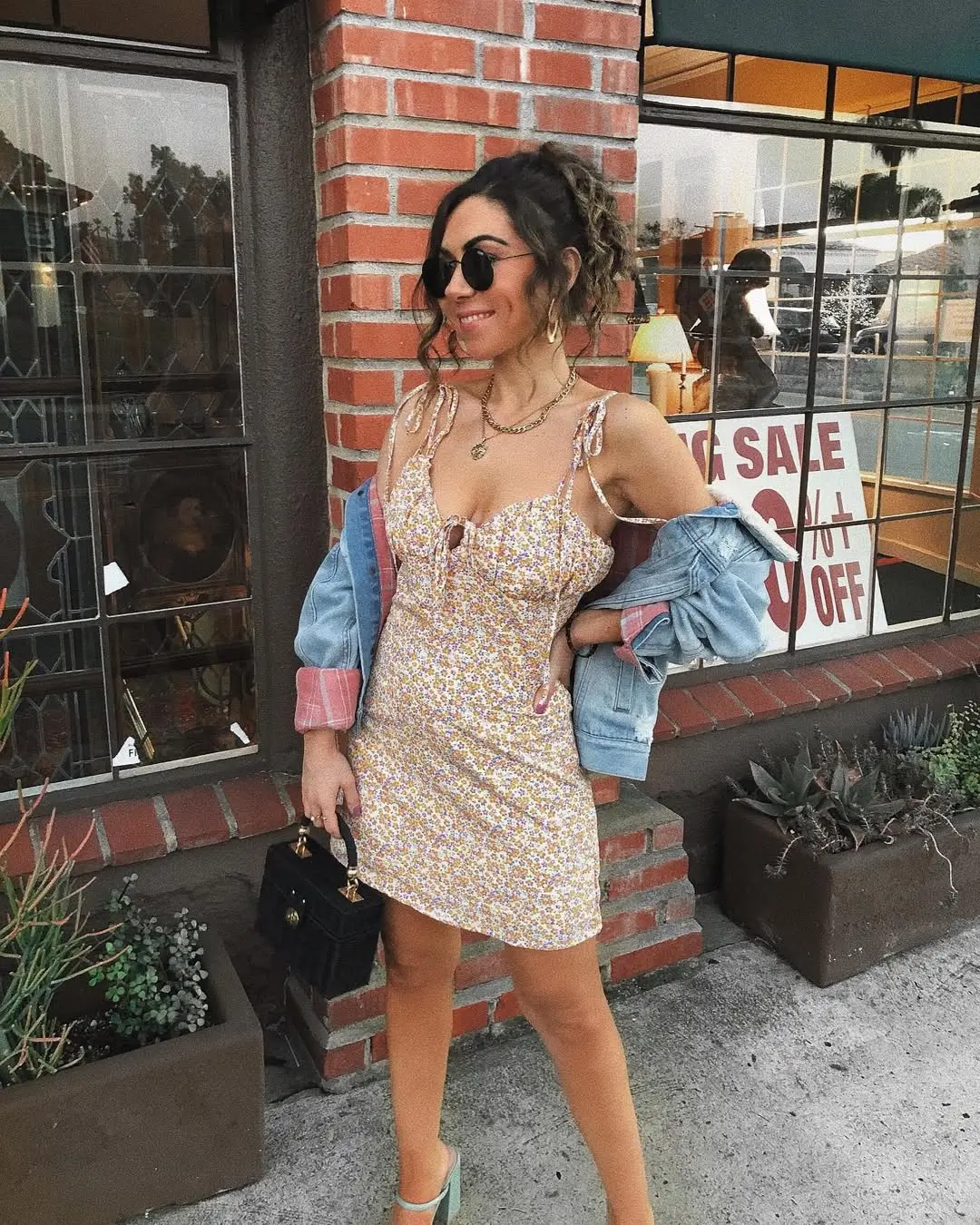 24 floral summer sleeveless dresses 2026 Casual yellow short floral dress styled with denim layers