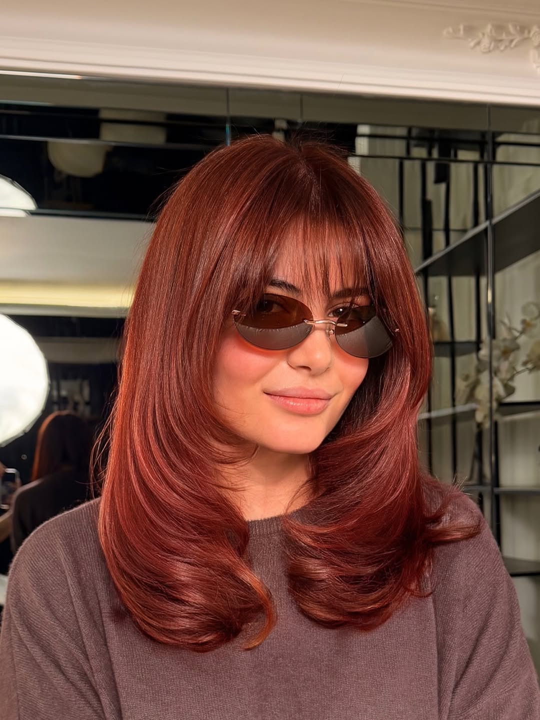 textured summer haircuts for medium hair 2026 Glossy Layered Blowout with Full Bangs Energy
