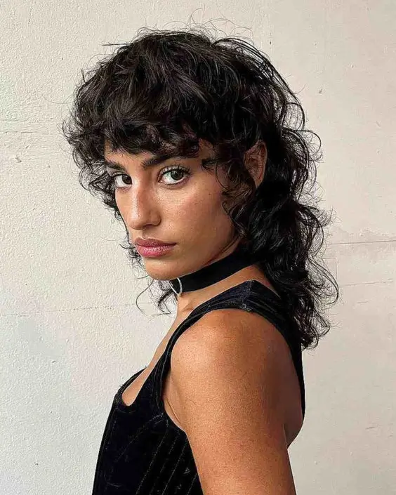 textured summer haircuts for thin fine hair 2026 Edgy textured shag with defined curls