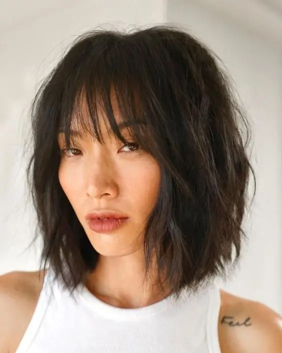 textured summer haircuts for thin fine hair 2026 Soft wavy bob with wispy fringe