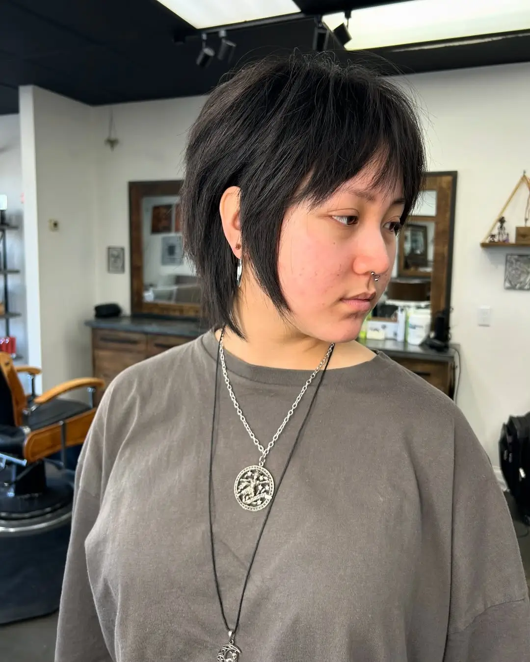 textured summer haircuts for thin fine hair 2026 Layered short shag with extended nape