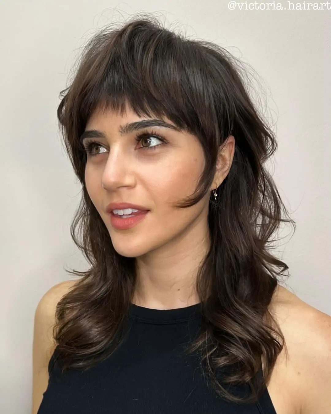 textured summer shag haircut 2026 Soft Layered Mid Length Shag With Wispy Bangs