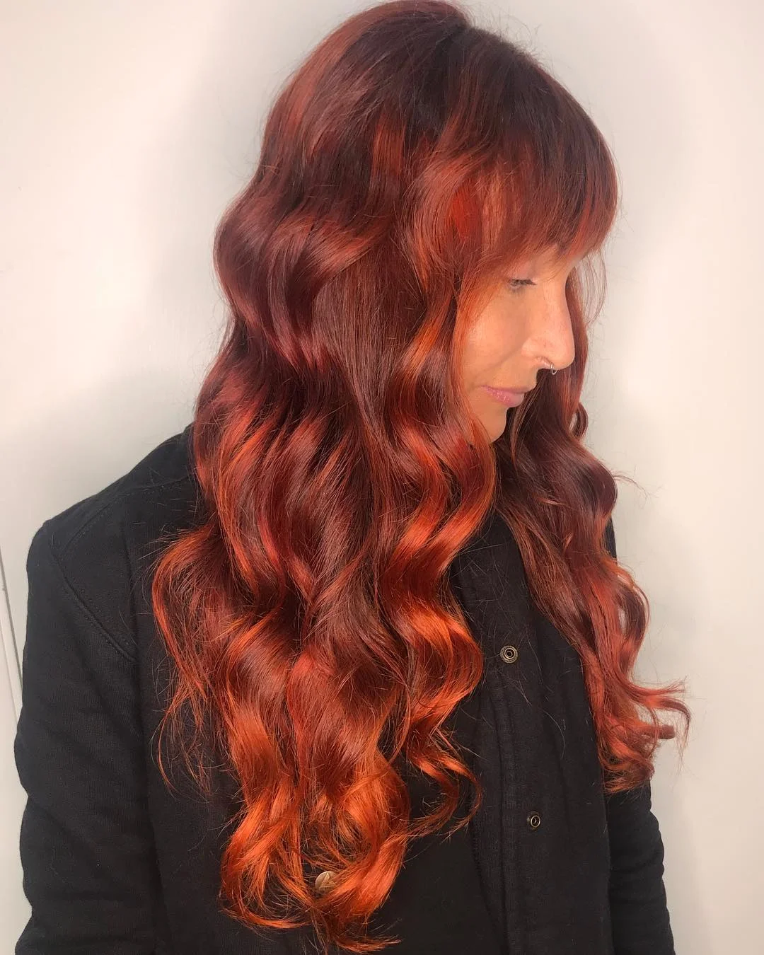 22 fiery summer copper balayage hair ideas 2026 Velvet Auburn Copper Curls With Wispy Fringe