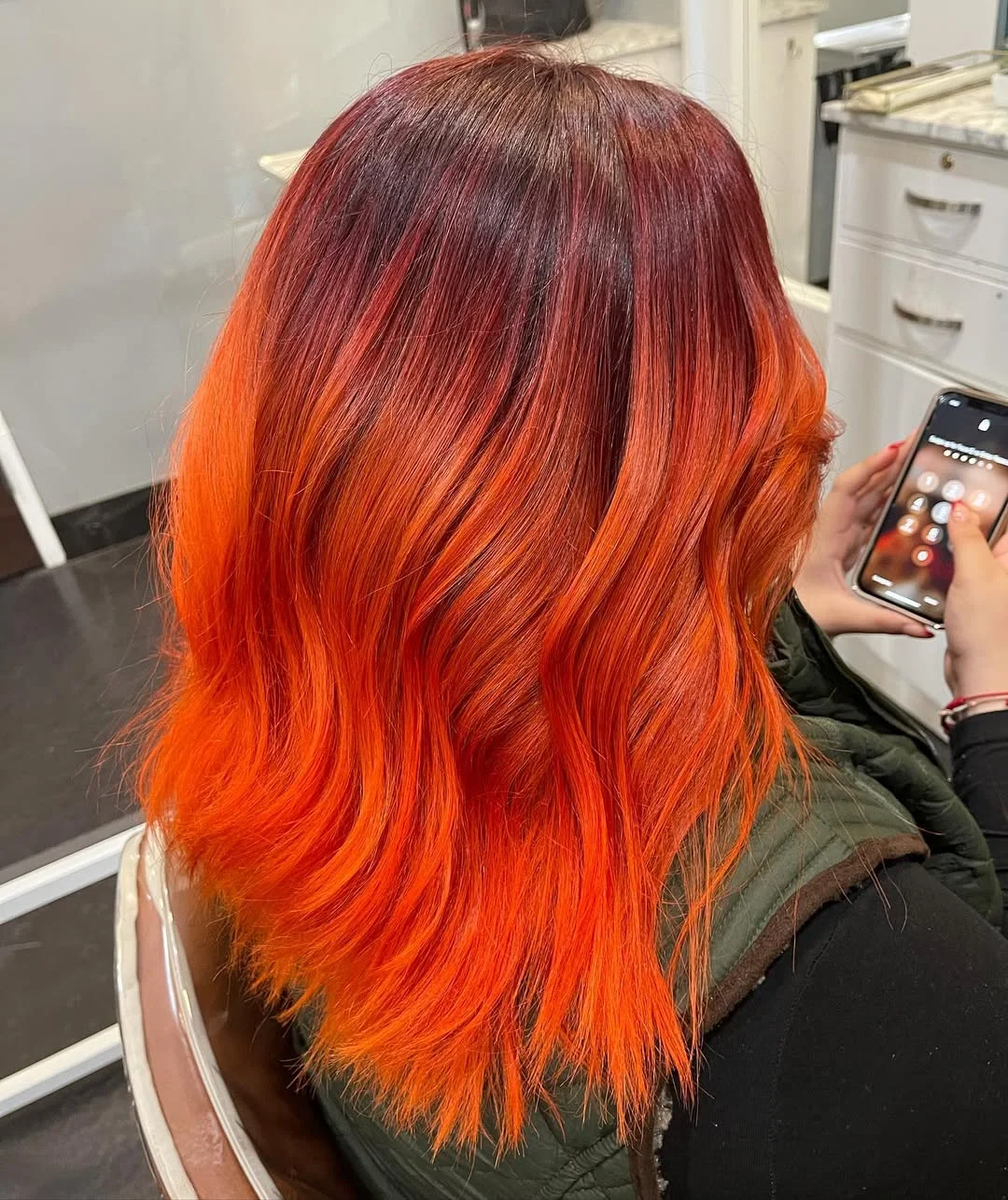 22 fiery summer copper balayage hair ideas 2026 Electric Orange Copper Balayage With Smoky Burgundy Roots