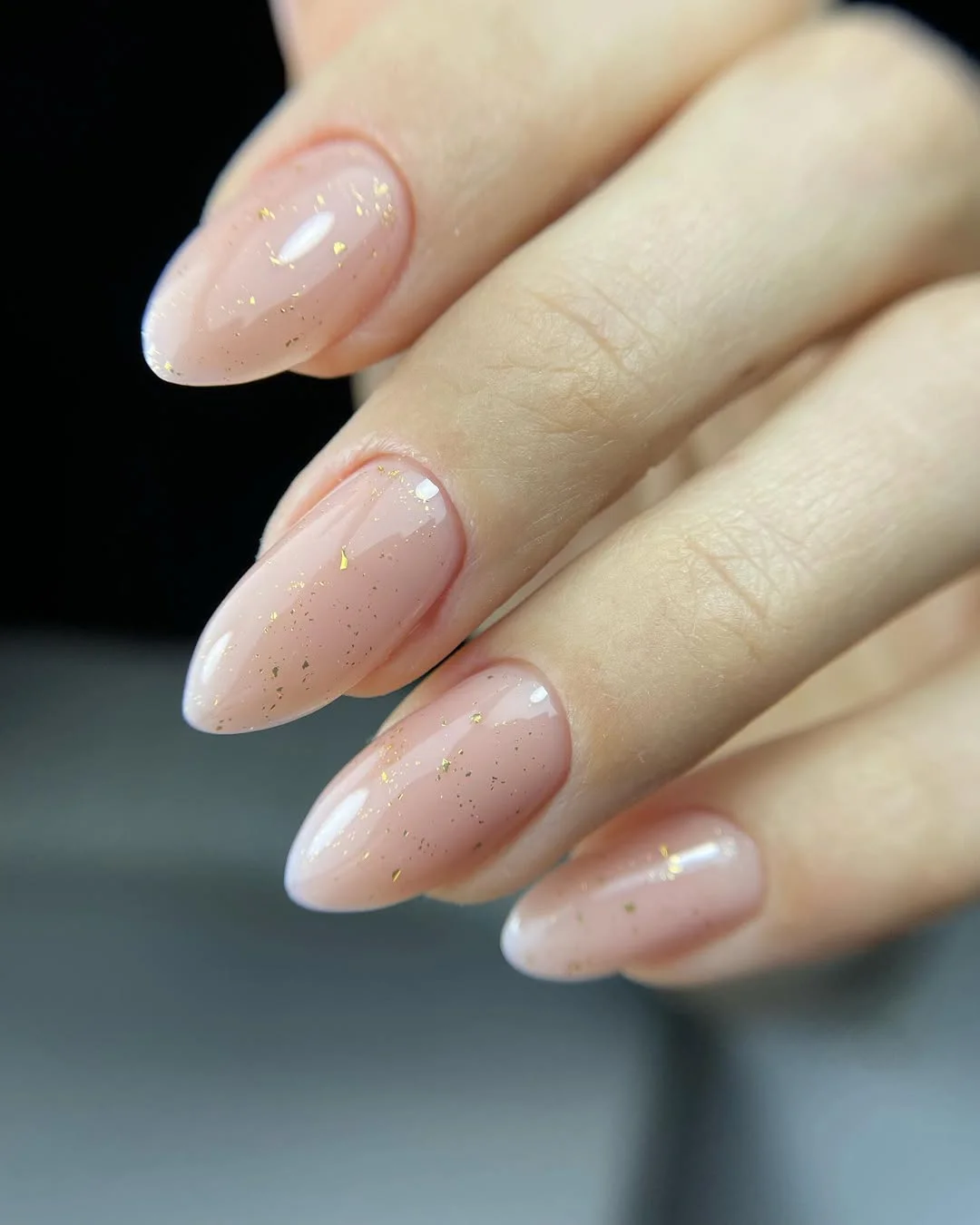 25 light summer nails 2026 Glossy Nude Almond Nails With Tiny Gold Foil Accents