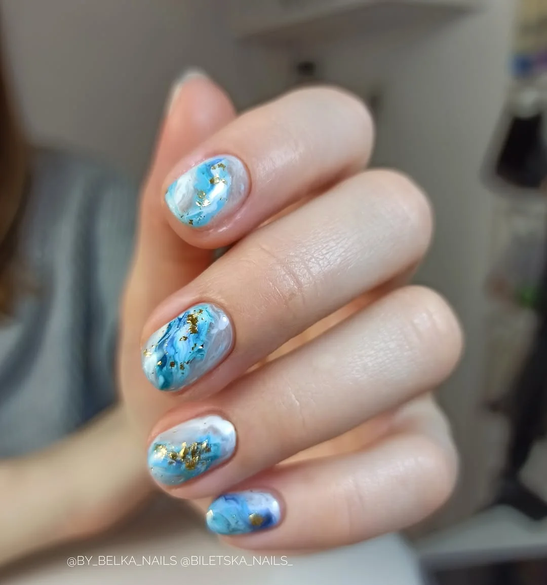 21 short summer nails 2026 Ocean Marble Nails With Gold Foil Details