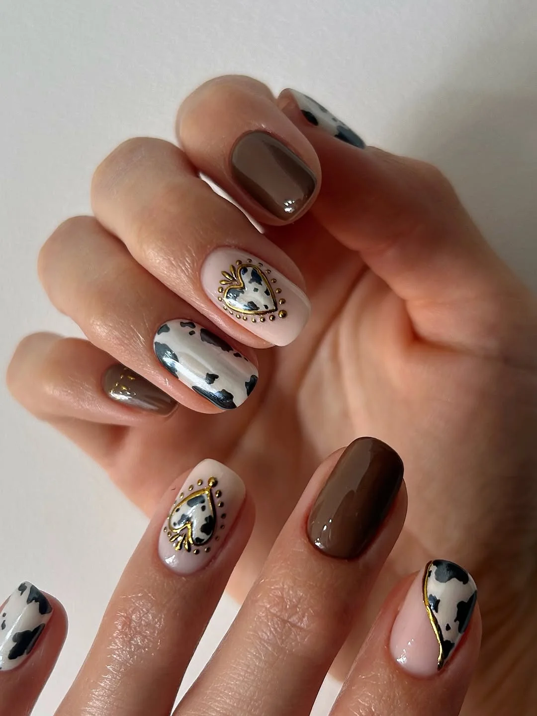 21 short summer nails 2026 Chocolate And Cow Print Nails With Western Summer Energy