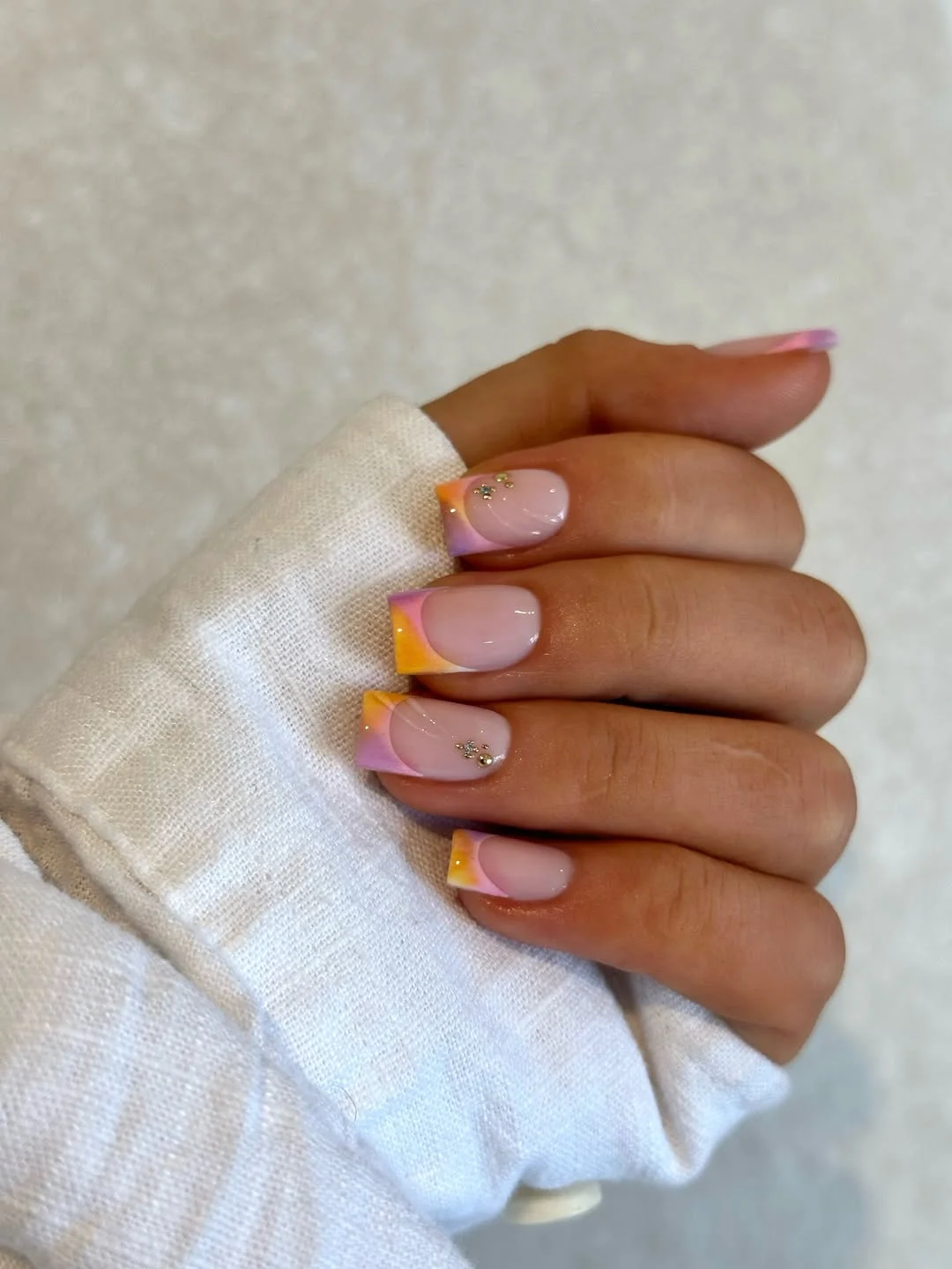 Summer French nails ideas 2026 Pastel Sunset French Tips With Tiny Crystal Details