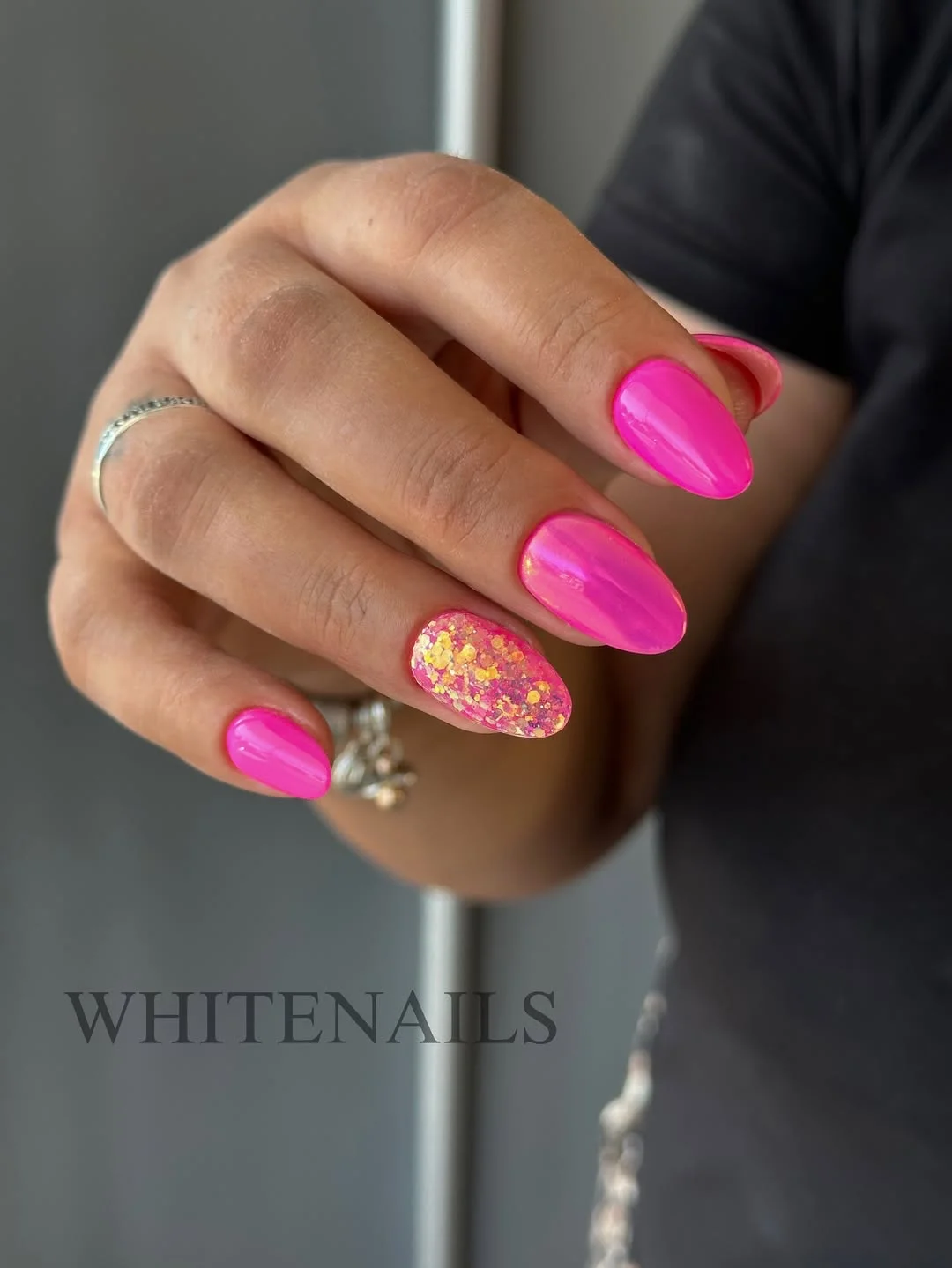 summer glitter nails 2026 Hot Pink Almond Nails With Glitter Spotlight Accent