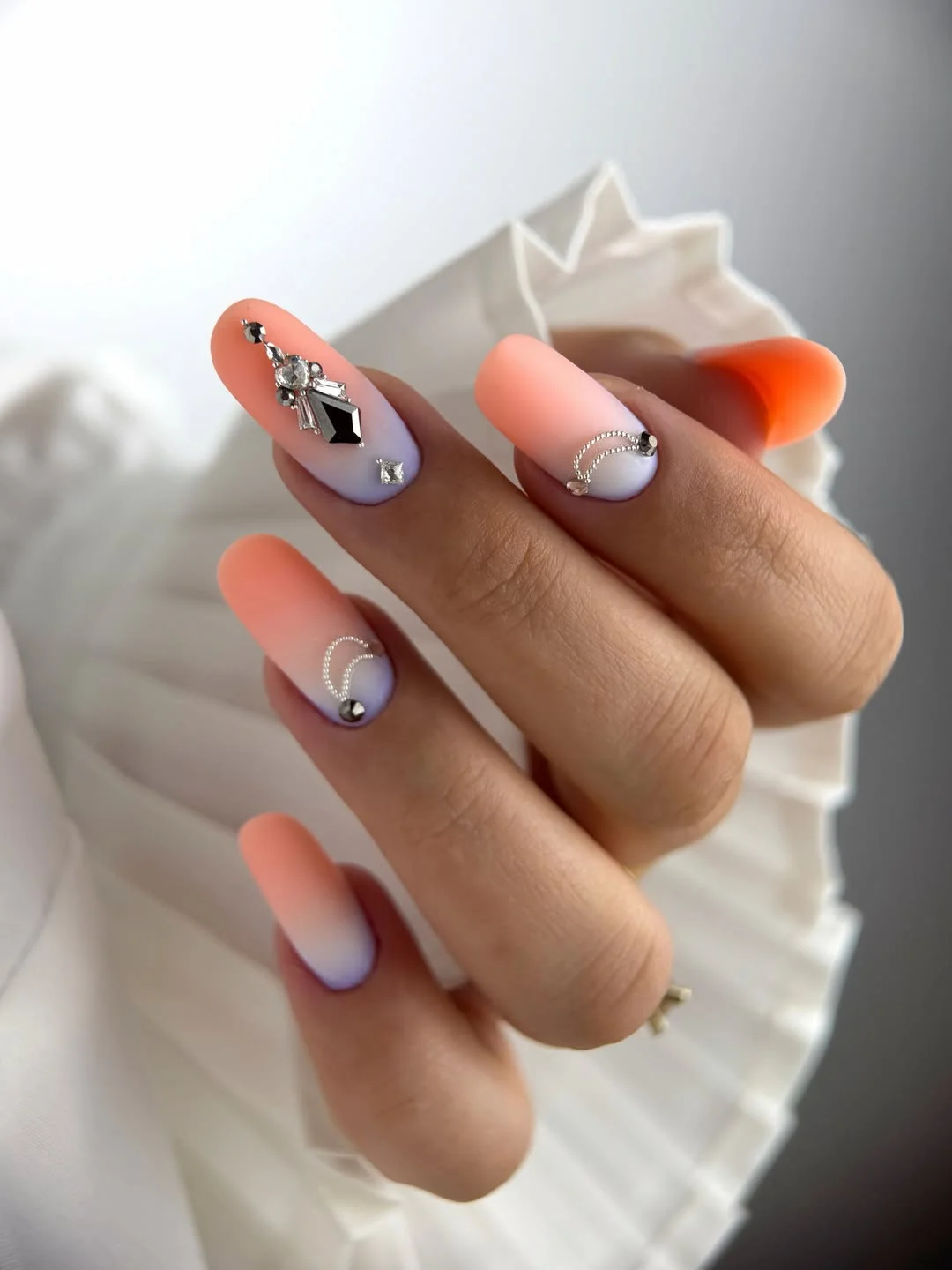 21 summer manicure color ideas 2026 Soft Peach Ombre Nails With Crystal Jewelry Accents
