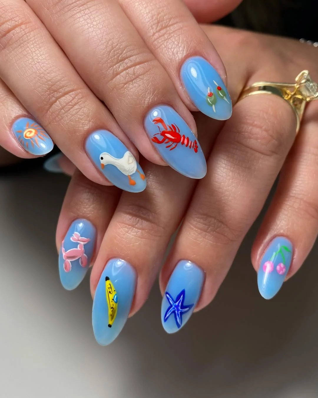 summer nail art 2026 Playful Mediterranean Blue Nails With Tiny Vacation Charms