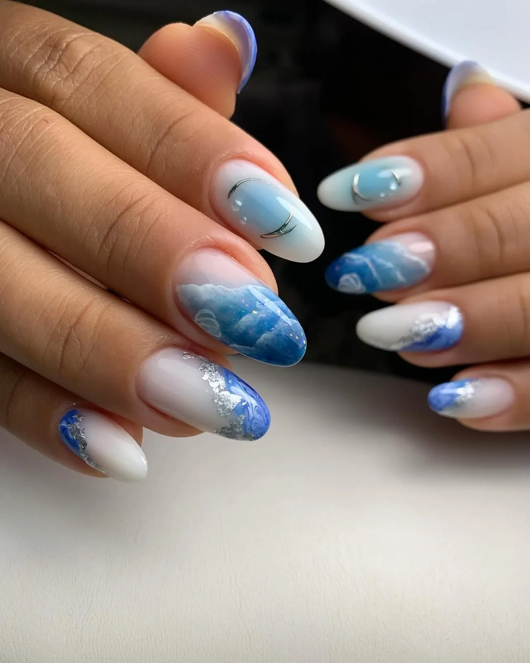 summer nail art 2026 Soft Ocean Marble Nails With Silver Foil Waves
