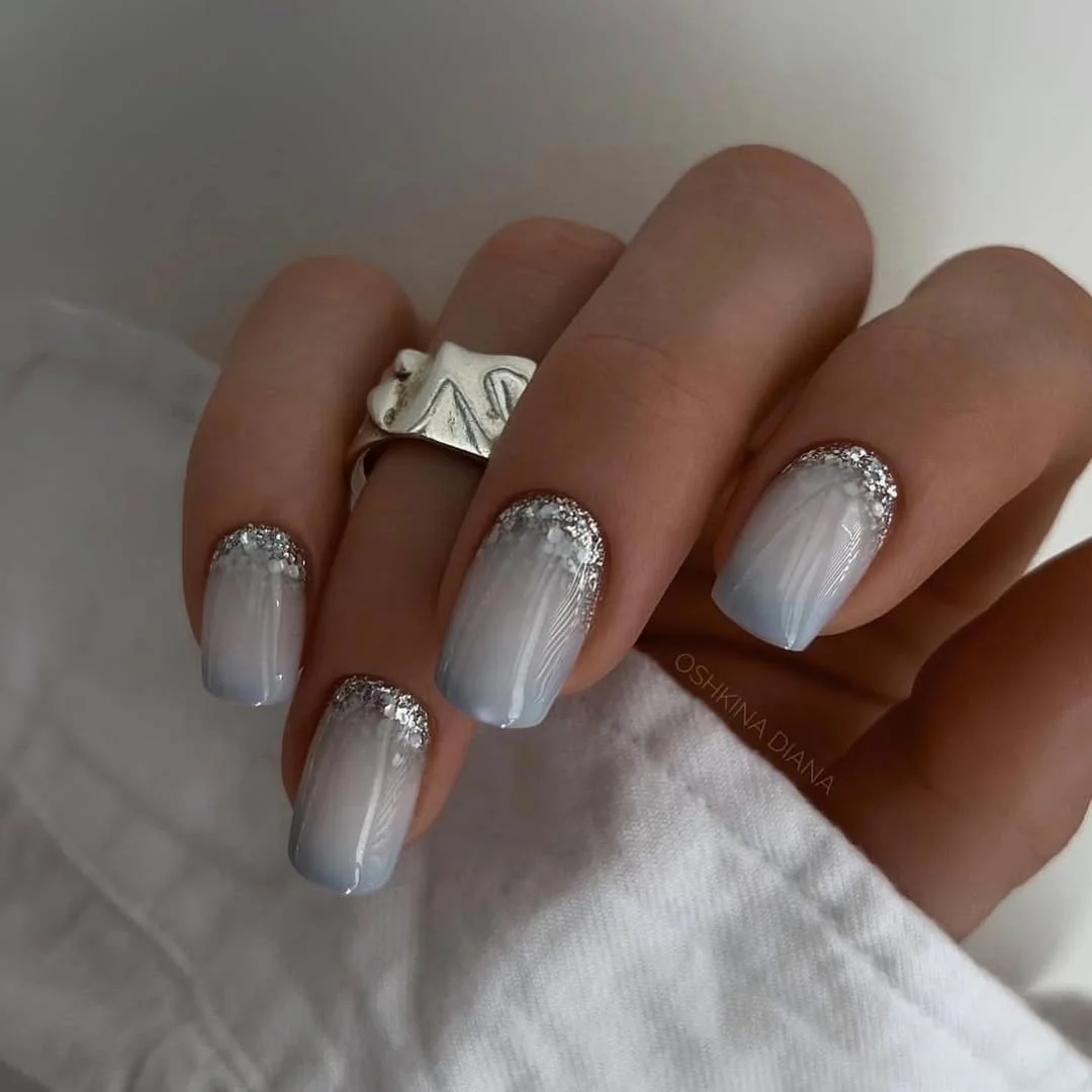 24 summer nail colors 2026 Ice White Pearl Nails With Silver Glitter That Feel Cool Against Summer Heat