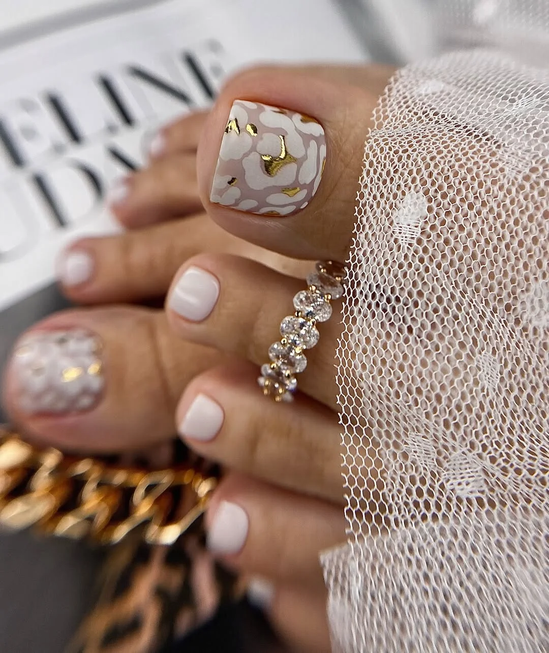 summer pedicure colors 2026 Soft White Floral Pedicure With Gold Details for Elegant Summer Days