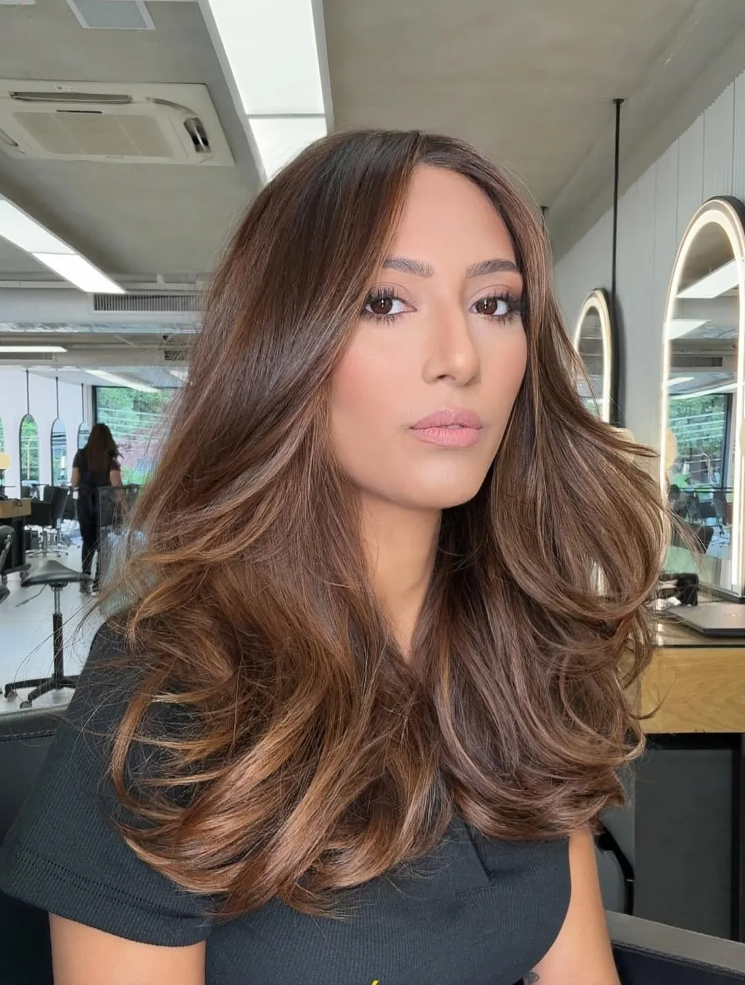 warm summer honey brown hair color 2026 Voluminous Honey Brown Blowout With Soft Layered Movement