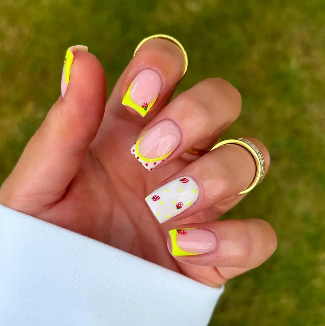 23 bright summer nails 2026 Neon Lemon French Tips With Tiny Strawberry Accents