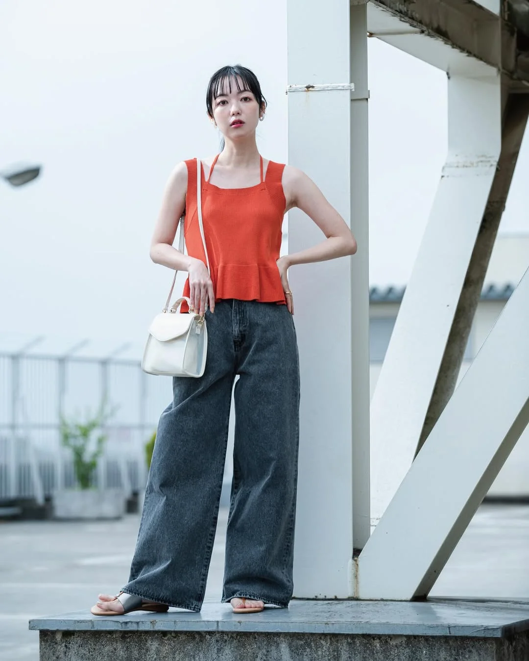 20 Early summer outfits 2026 Bright Coral Knit Top with Relaxed Wide-Leg Jeans