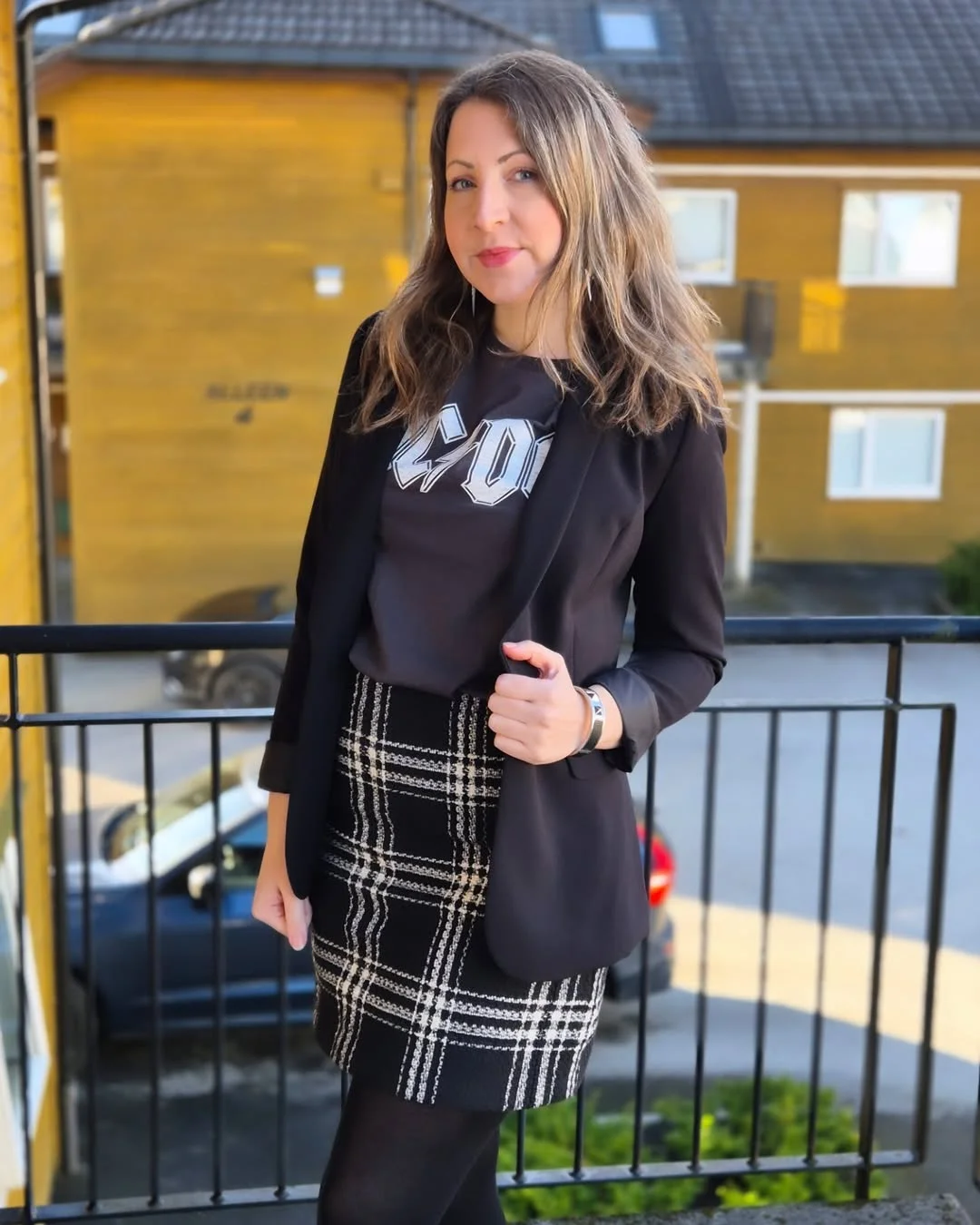 21 fall work outfits 2026 Graphic Tee and Plaid Skirt with Modern Business Casual Energy