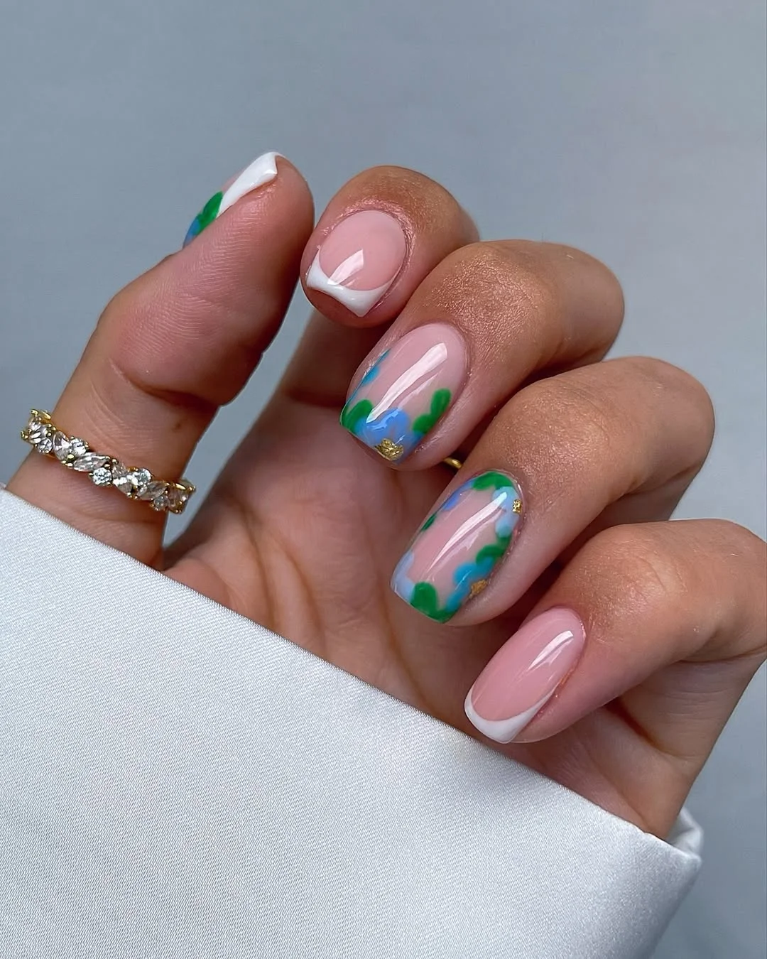 23 July nails design ideas 2026 Soft Botanical French Tips With Gold Accents