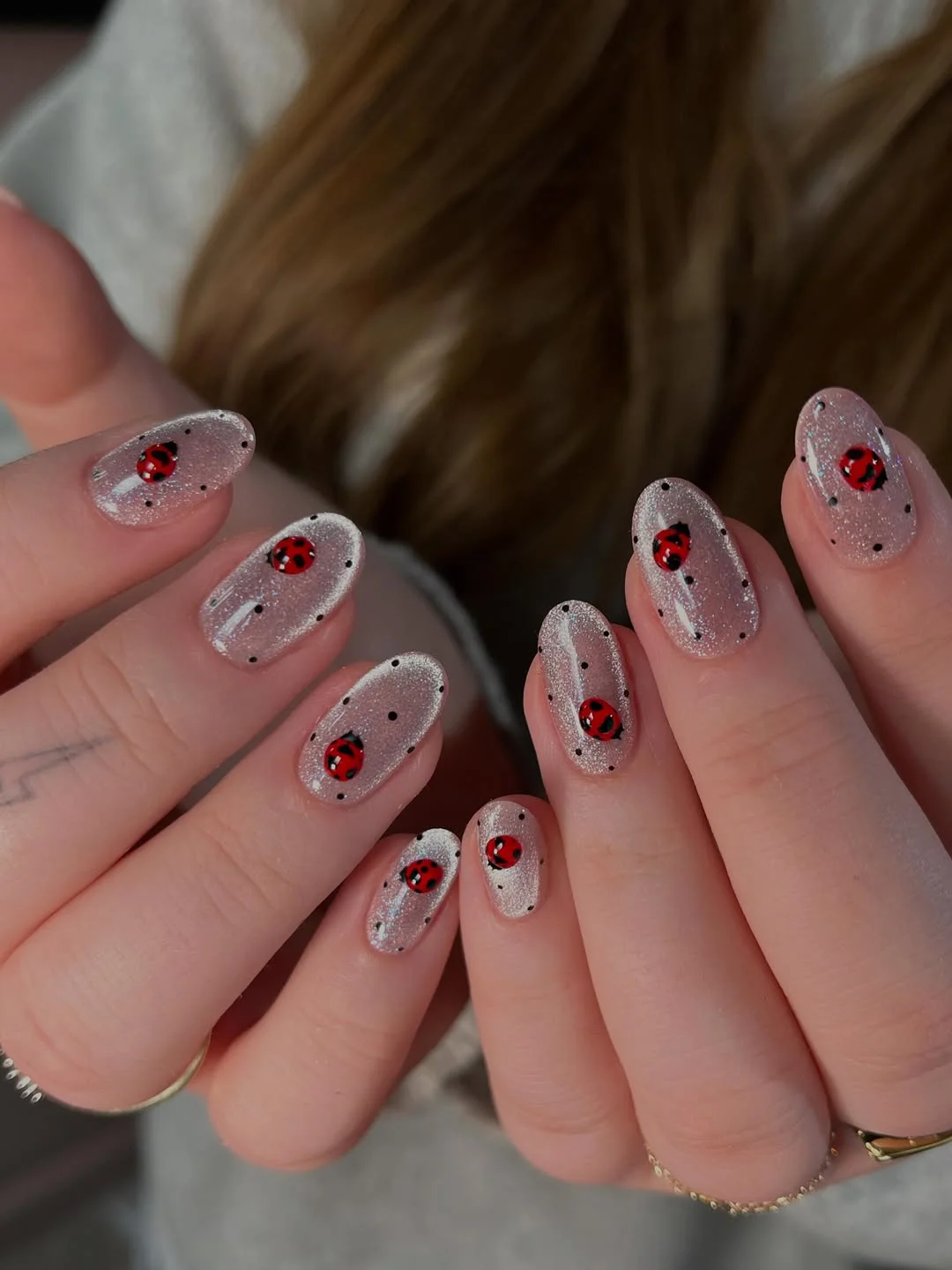 23 July nails design ideas 2026 Silver Glitter Nails With Tiny Ladybug Art