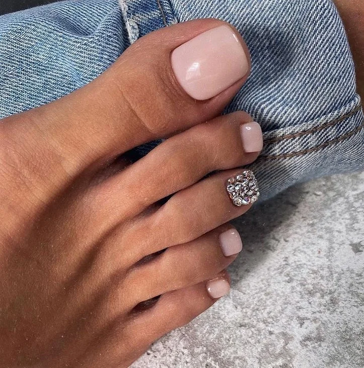 21 July toe nail colours ideas 2026 Soft Nude Pink With Crystal Accent Detail