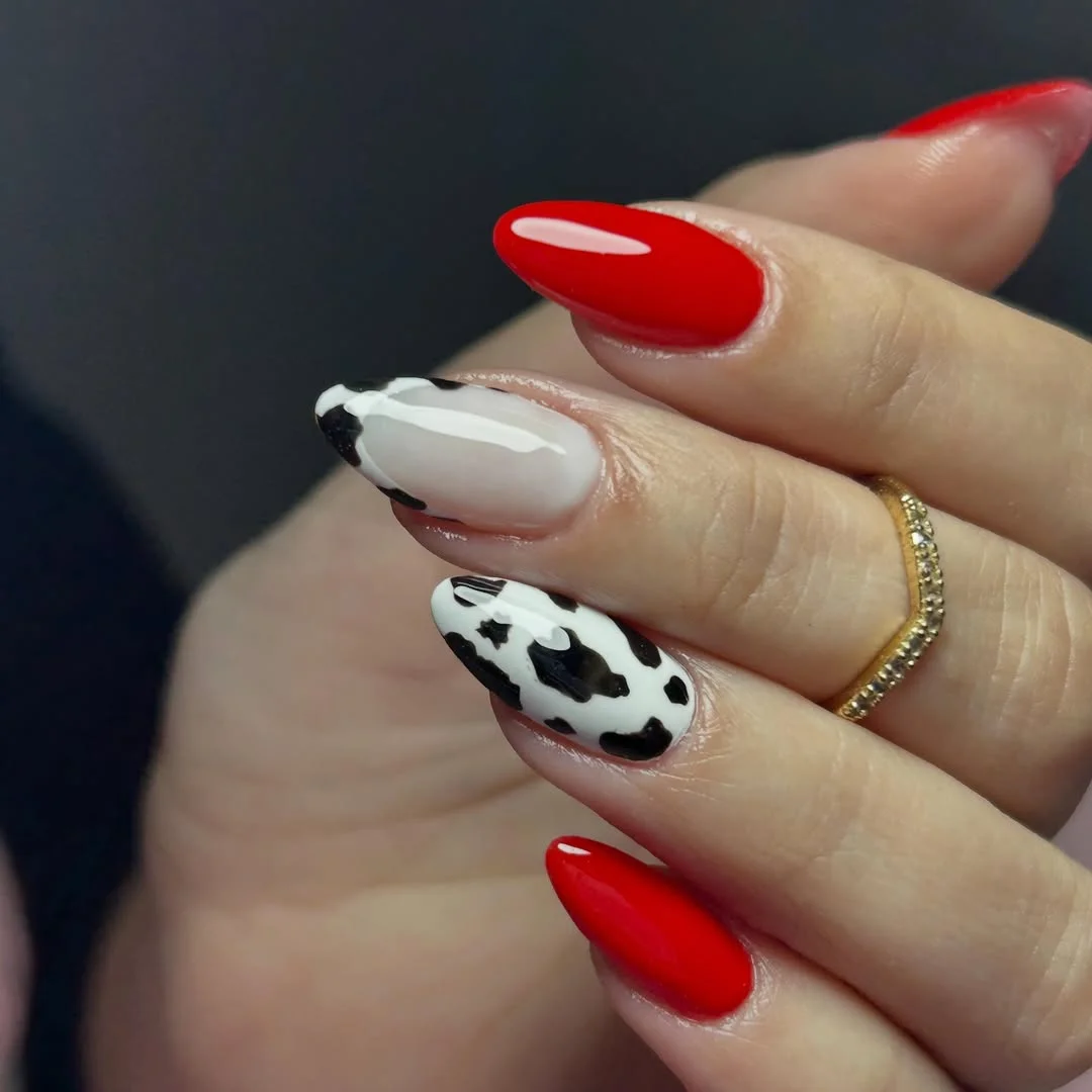 20 June manicure ideas 2026 Red and Cow Print Nails with Western Flair