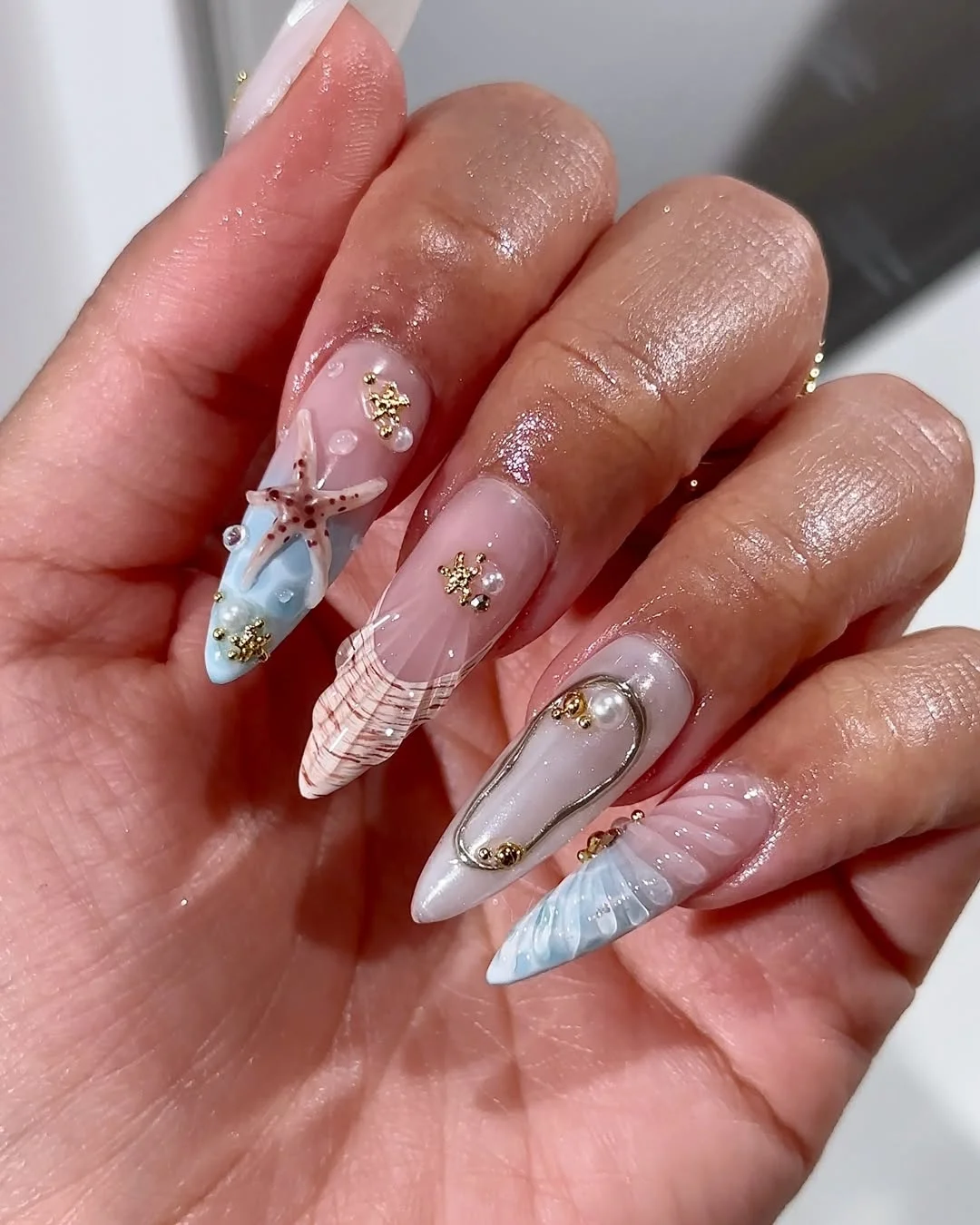 24 starfish summer nails 2026 Gold Starfish Details on Soft Nude Almond Nails