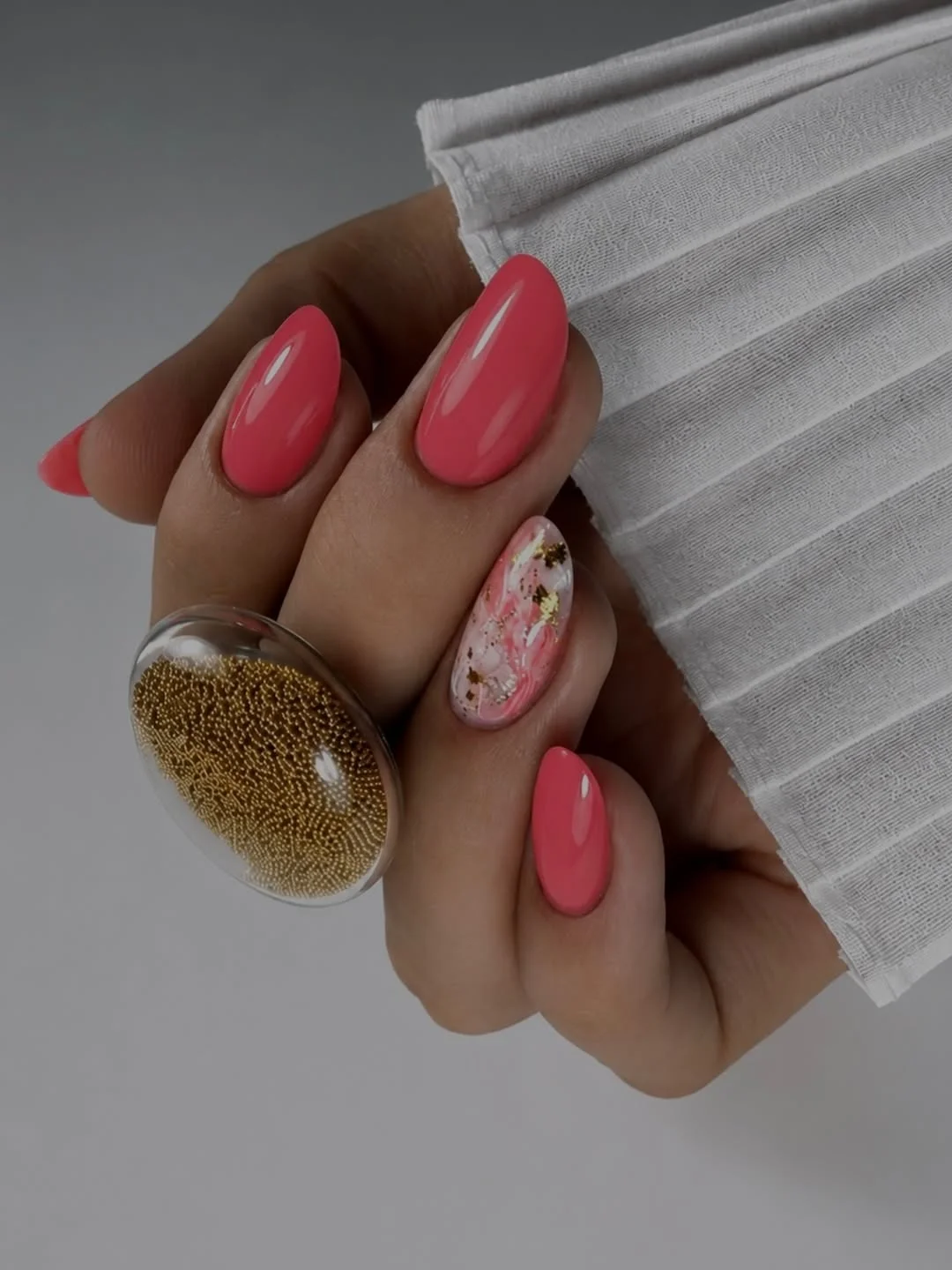 21 summer oval nails 2026 Glossy Coral Pink Nails With Luxe Marble Accent Art