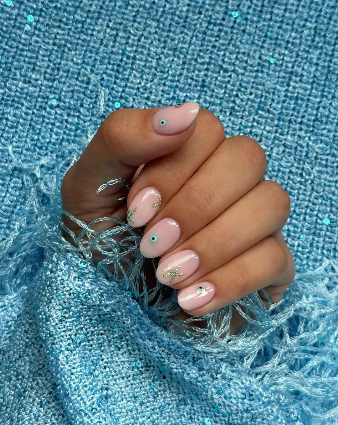 21 summer oval nails 2026 Soft Pink Evil Eye Nails With Delicate Coastal Details
